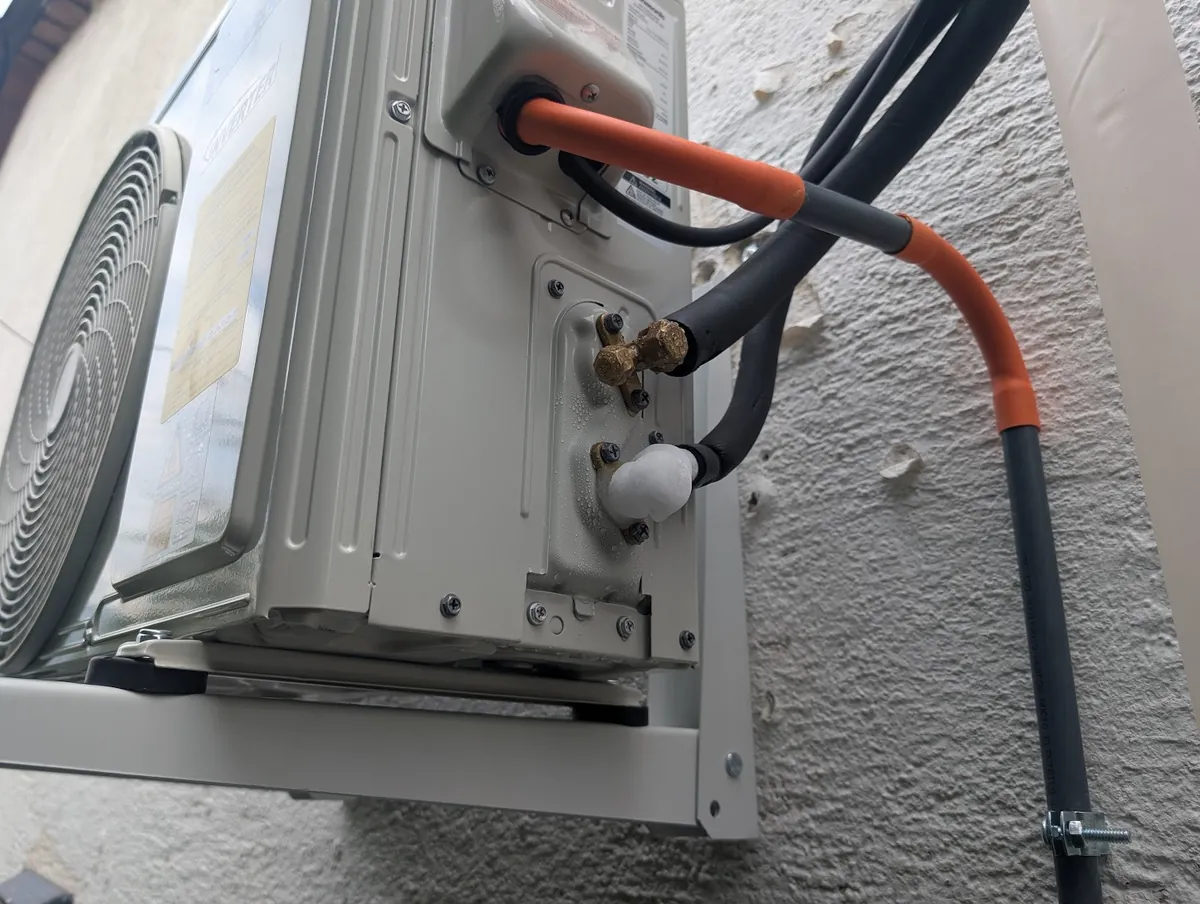 Ice formed on the suction service valve of an R-32 mini-split condenser